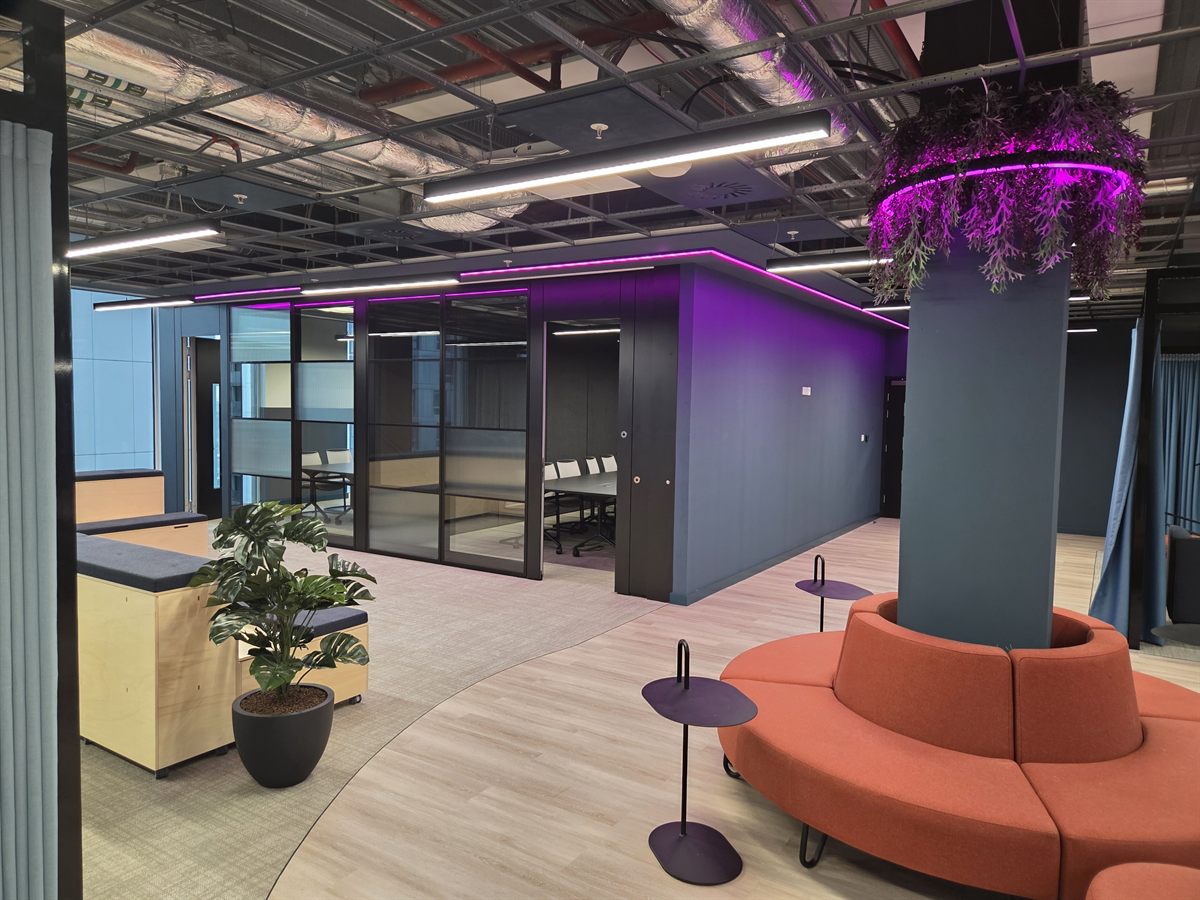 Office Fit-Out MediaCityUK Salford Open-plan breakout with glazed meeting pods and curved feature seating, office fit-out MediaCityUK Salford by JDCM Ltd